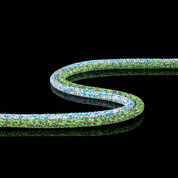 Blue and green Poly Tec rope on display in a S pattern on black glossy background.